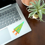 Laptop with a colorful a colorful Pennant-shaped sticker that says "What if It All Works Out" 