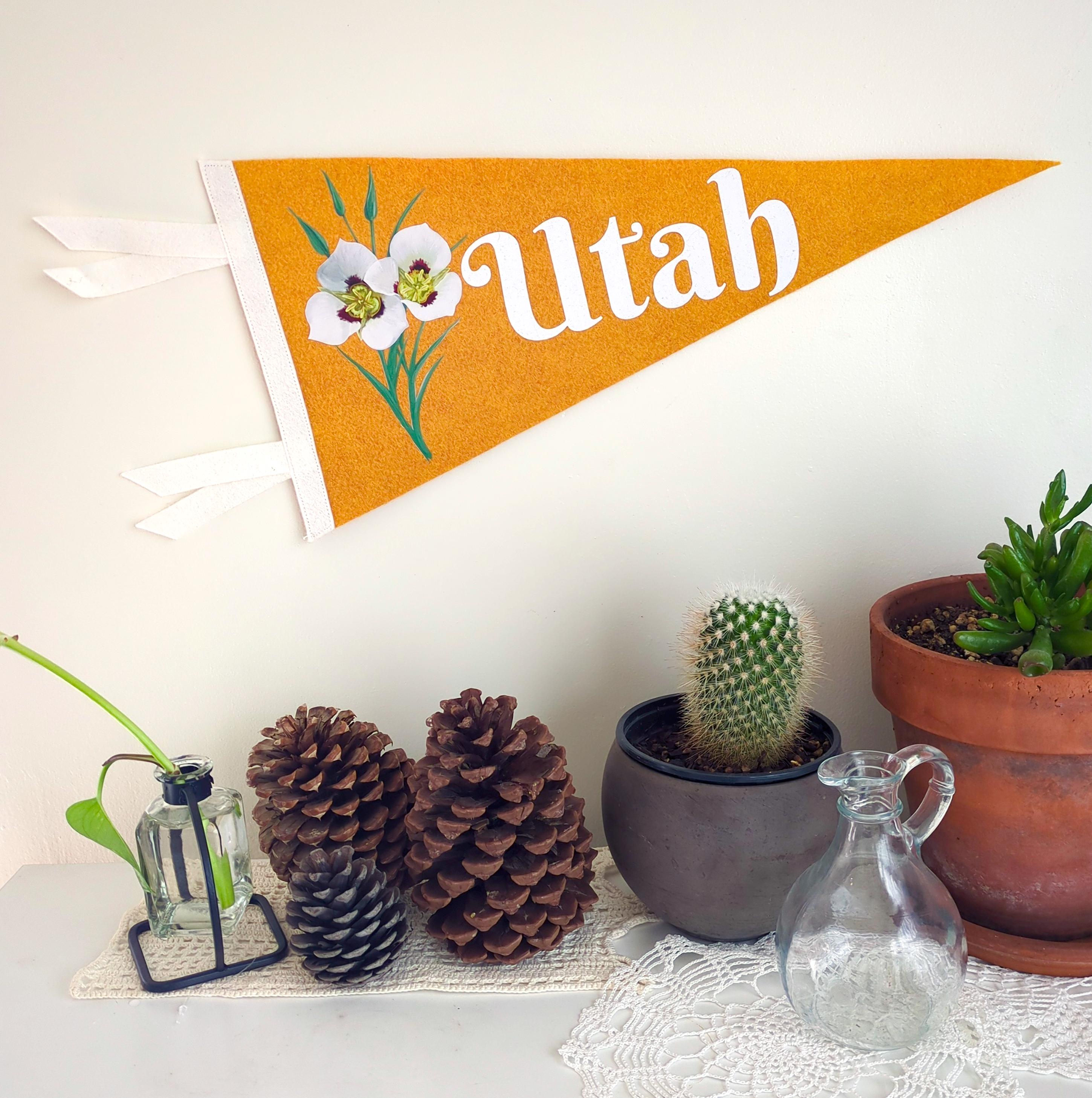 Decorative 'Utah' banner with plants and decorative items on a table.
