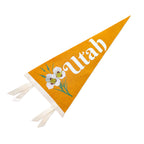Mustard yellow pennant with 'Utah' and a sego lily design on a white background